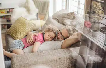 Mann mit Tochter machen ein Mittagsschlaf! Optimal dank Lärmschutzfenster geschützt.