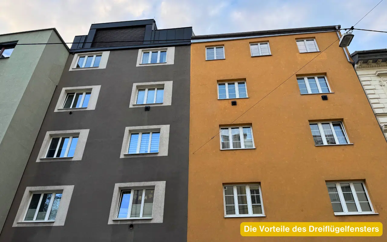 Die Vorteile des Dreiflügelfensters – Wohnhausfassaden in Grau und Orange mit weißen Fenstern in mehreren Etagen