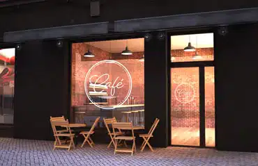 Eingangstüren für Geschäfte und Gewerbe mit großer Glasfront und moderner Beschriftung am Beispiel eines stilvollen Cafés.