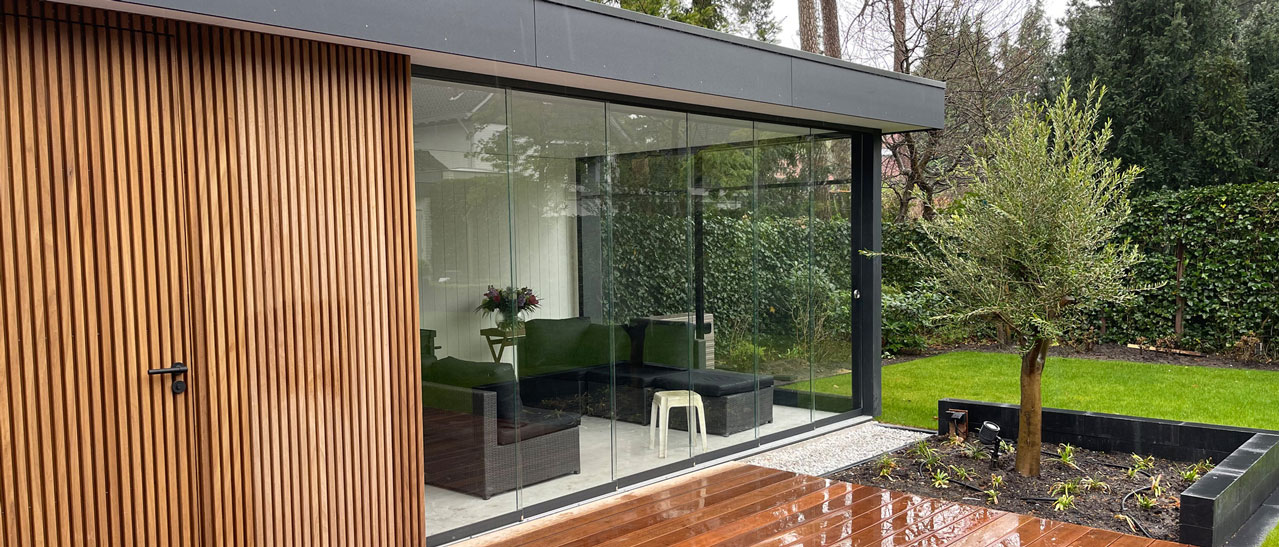 Sunflex Glasschiebewände verwandeln Poolhaus in geschütztes Sommerwohnzimmer mit Glas-Seitenwänden.