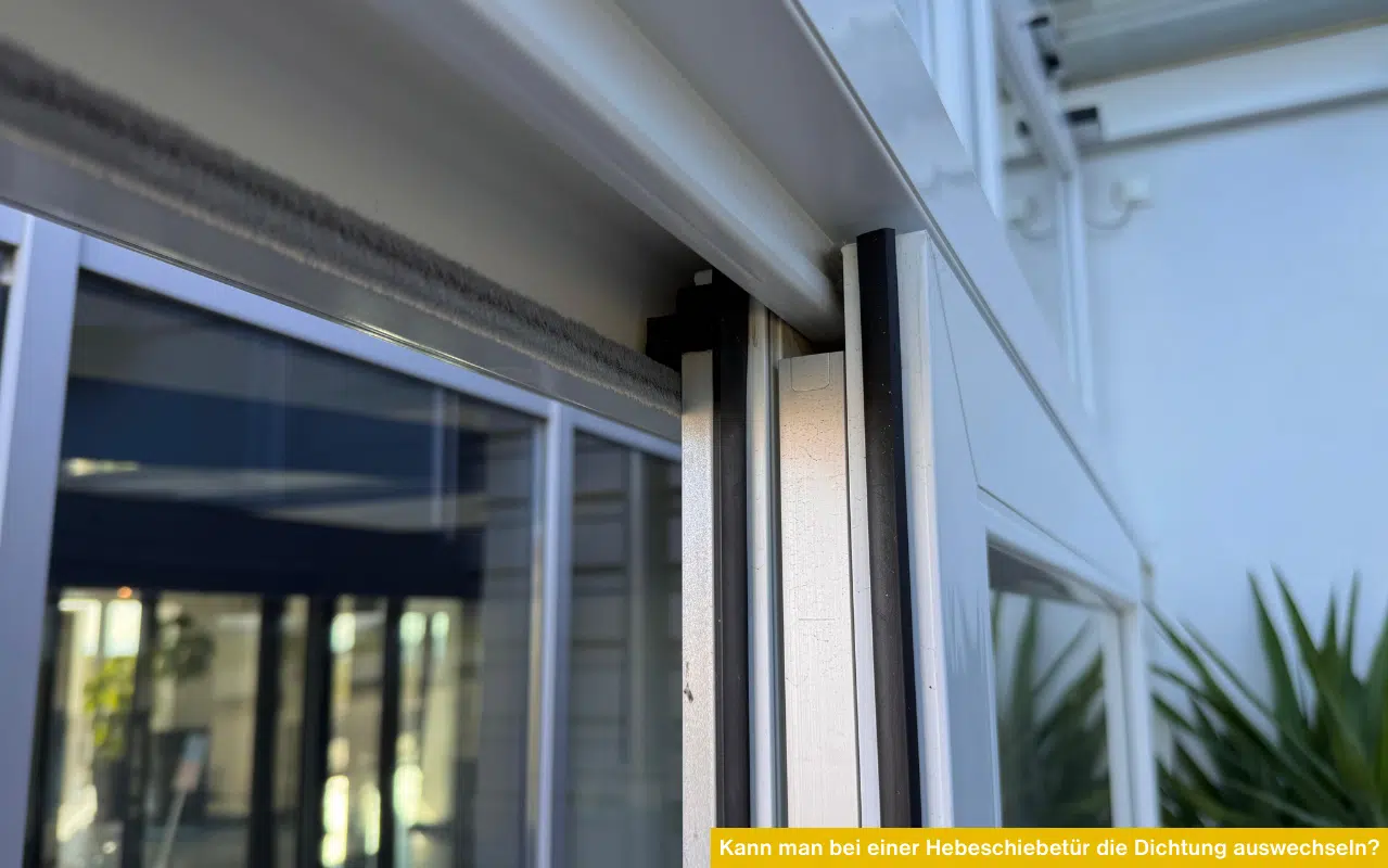 Detailansicht einer weißen Hebeschiebetür mit Fokus auf die Gummi- und Bürstendichtungen im Profil.