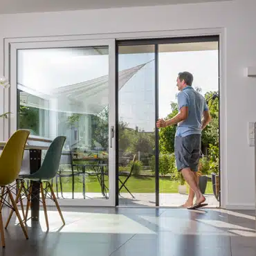 Familienvater montiert Insektenschutz-Plissee an Kunststoff-Alu Hebeschiebetür.