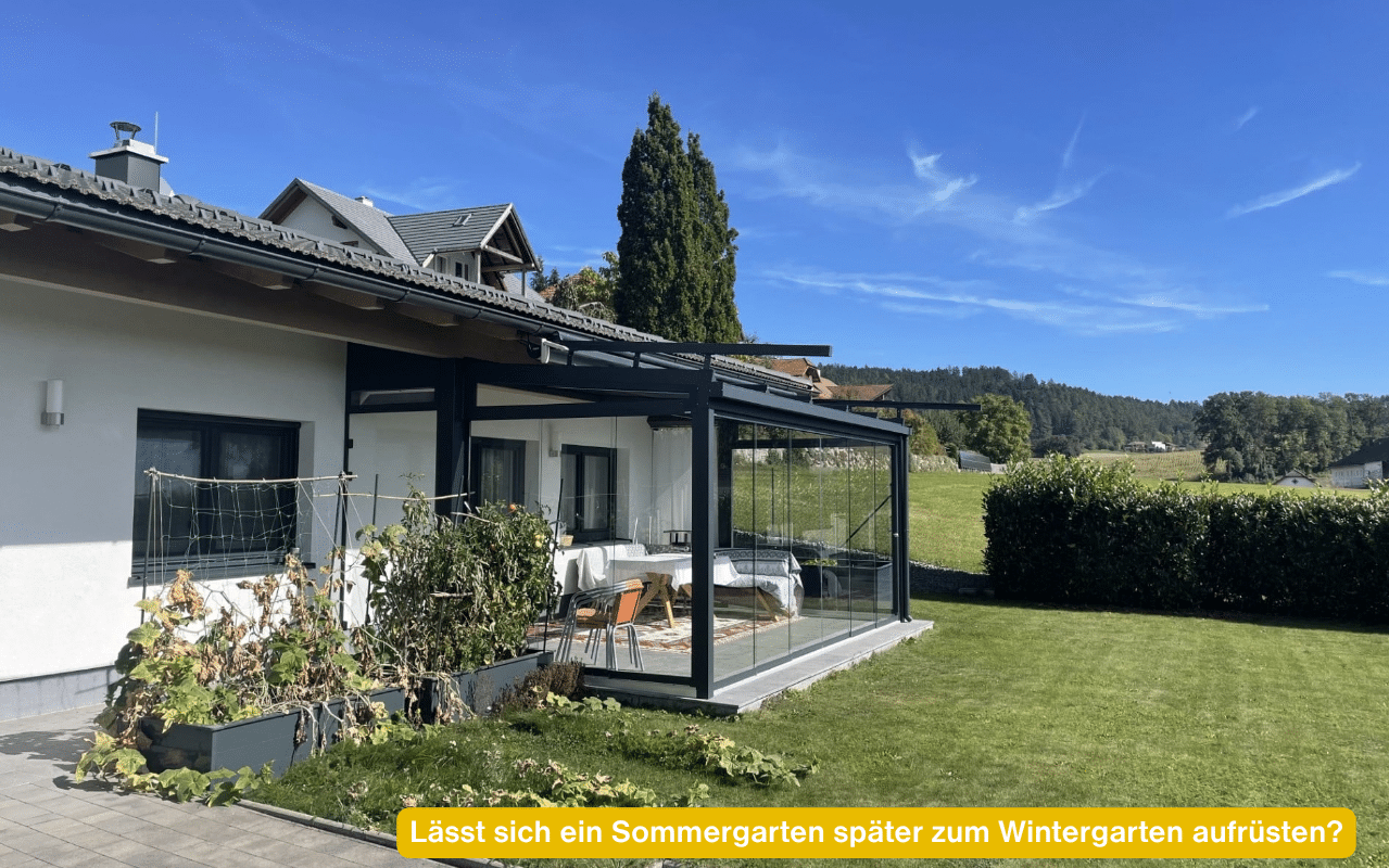 Lässt sich ein Sommergarten später zum Wintergarten aufrüsten? Kaltwintergarten in Anthrazit mit Glasschiebetüren an einem Einfamilienhaus