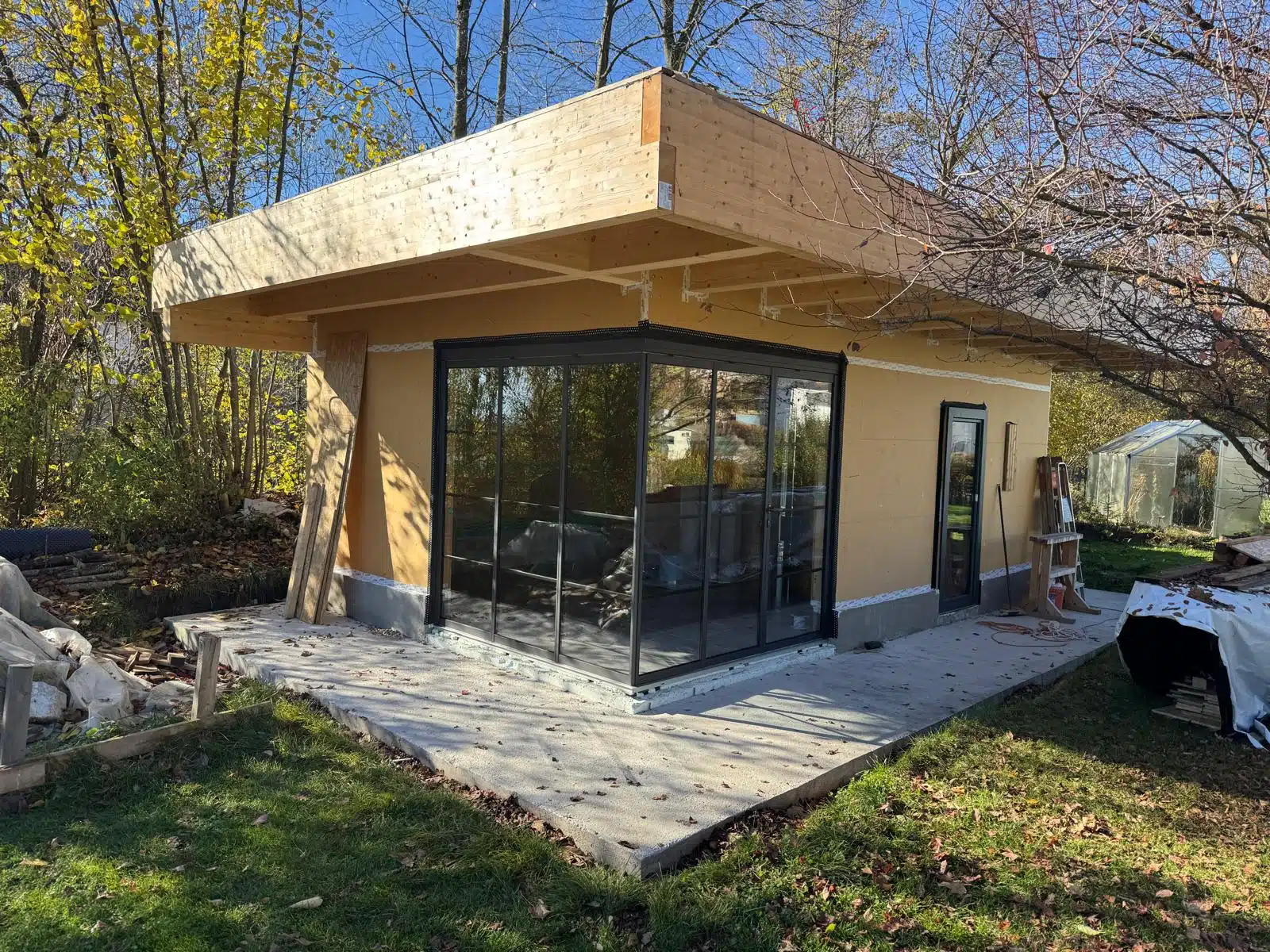 Modernes Gartenhaus mit Sunflex Schiebe-Dreh-System und Sprossen im Rohbau