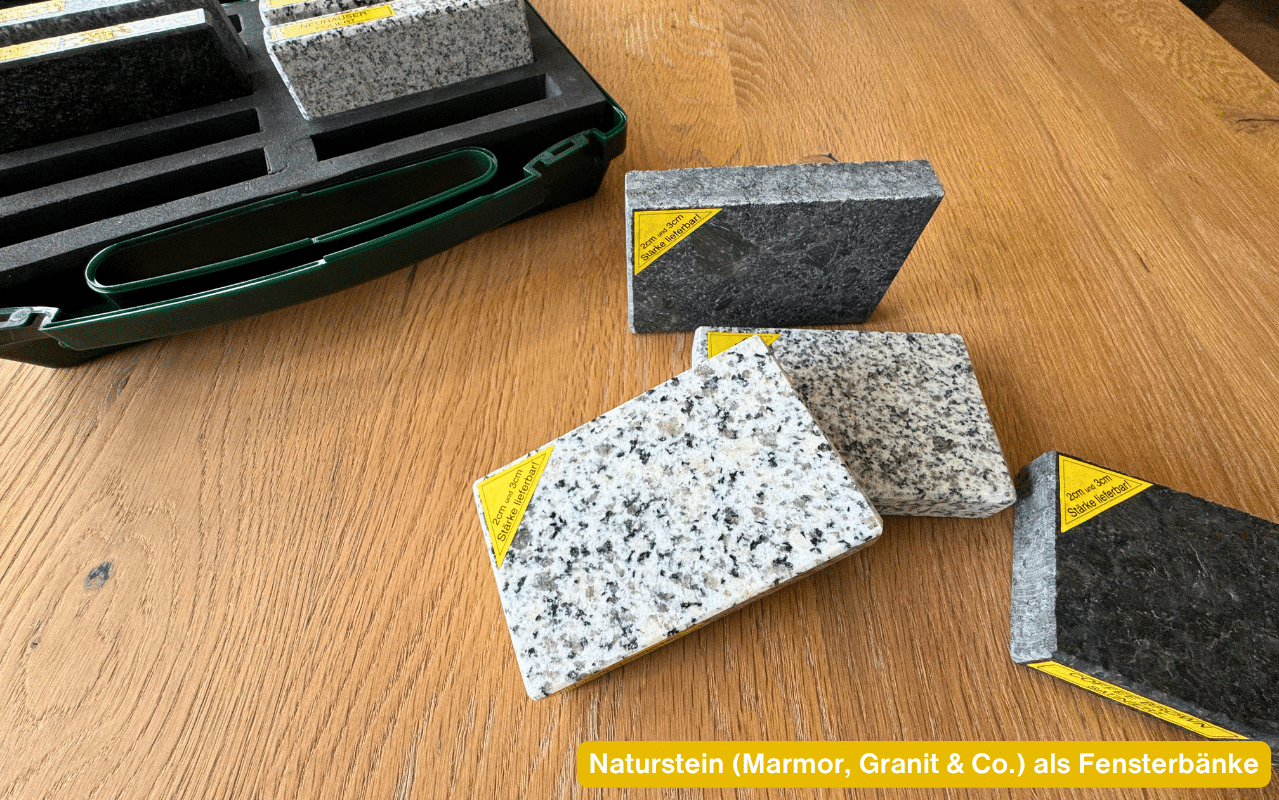Naturstein Marmor Granit und Co als Fensterbänke – verschiedene Steinmuster in unterschiedlichen Farben auf einem Holztisch
