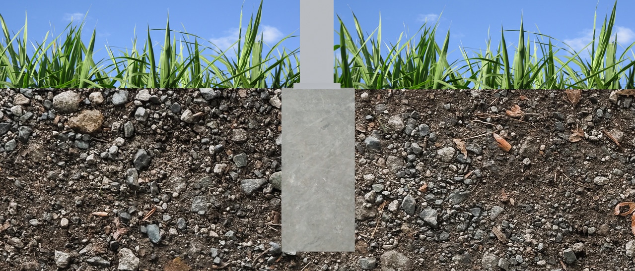 Das Bild zeigt ein Punktfundament im Querschnitt. Ein einzelner Betonblock ist tief im Erdreich eingelassen, darüber ragt ein Trägerpfosten heraus. Die Konstruktion ist von Erde und Gras umgeben.