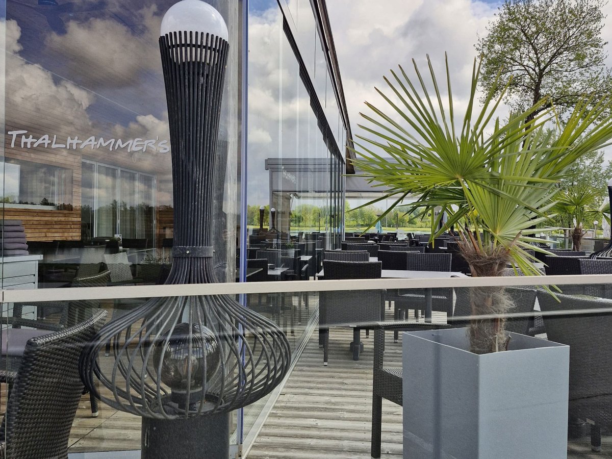 Ganzglas-Schiebeelemente über Eck an der Terrasse eines Seerestaurants in Feldkirchen an der Donau