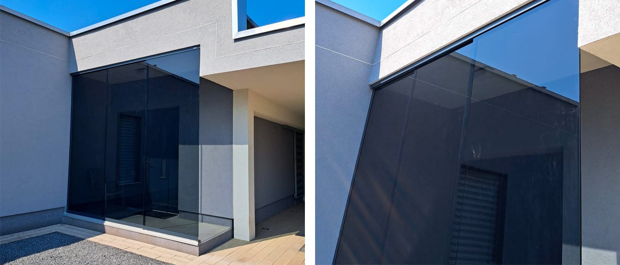 Großflächiger Seitenwindschutz für Hauseingänge vom Glaser - maßgefertigte Glaslösung schützt elegant vor Wind und Wetter.