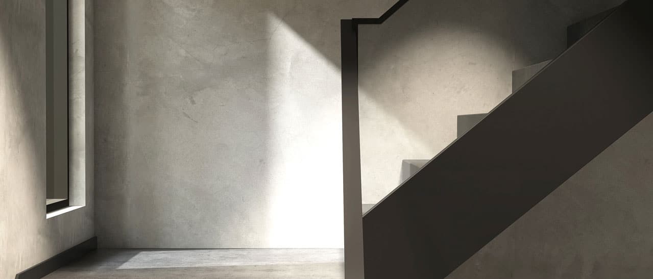 Modernes Stiegenhaus in Betonoptik mit einem schwarzen Stiegenhausfenster als eine Festverglasung mit Sicherheitsglas ausgeführt.
