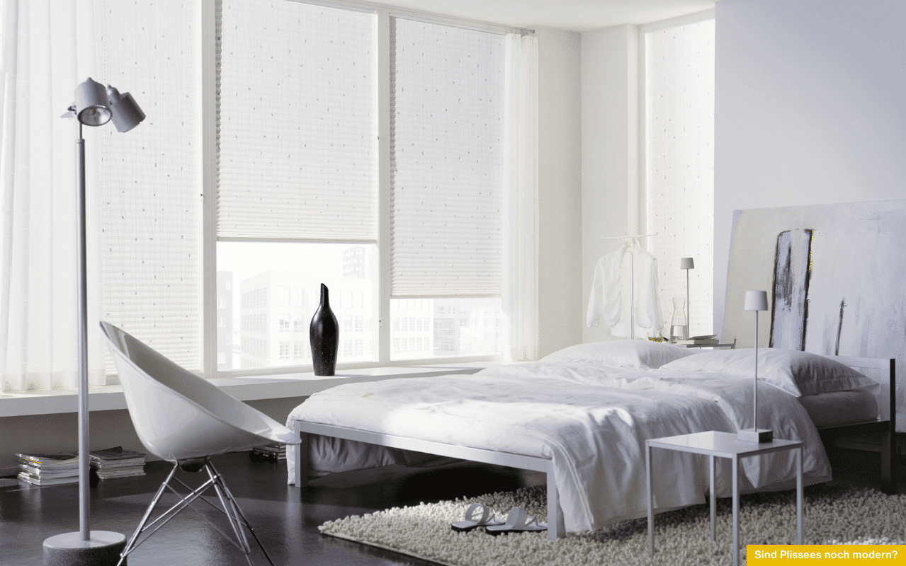 Sind Plissees noch modern? Stilvolles Schlafzimmer mit modernen Plissees als Sichtschutz und Lichtfilter an großen Fensterflächen.