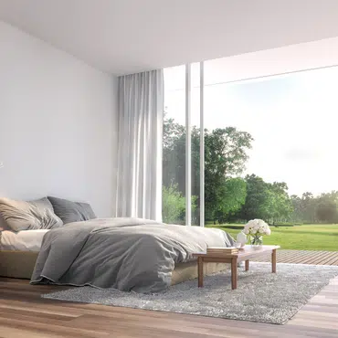 Terrassentüren Preise in Oberösterreich modernes Schlafzimmer mit großen Glasflächen und Blick ins Grüne für lichtdurchflutetes Wohnen.