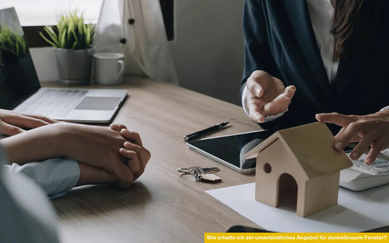 Wie erhalte ich ein unverbindliches Angebot für dunkelbraune Fenster Beratungsgespräch mit Hausmodell und Laptop am Tisch