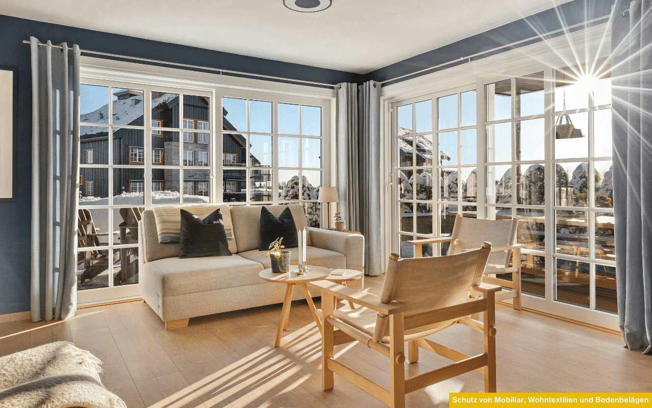 Wohnzimmer mit großer Fensterfront, Schutz von Mobiliar, Wohntextilien und Bodenbelägen durch Sonnenschutz und UV-Filter.